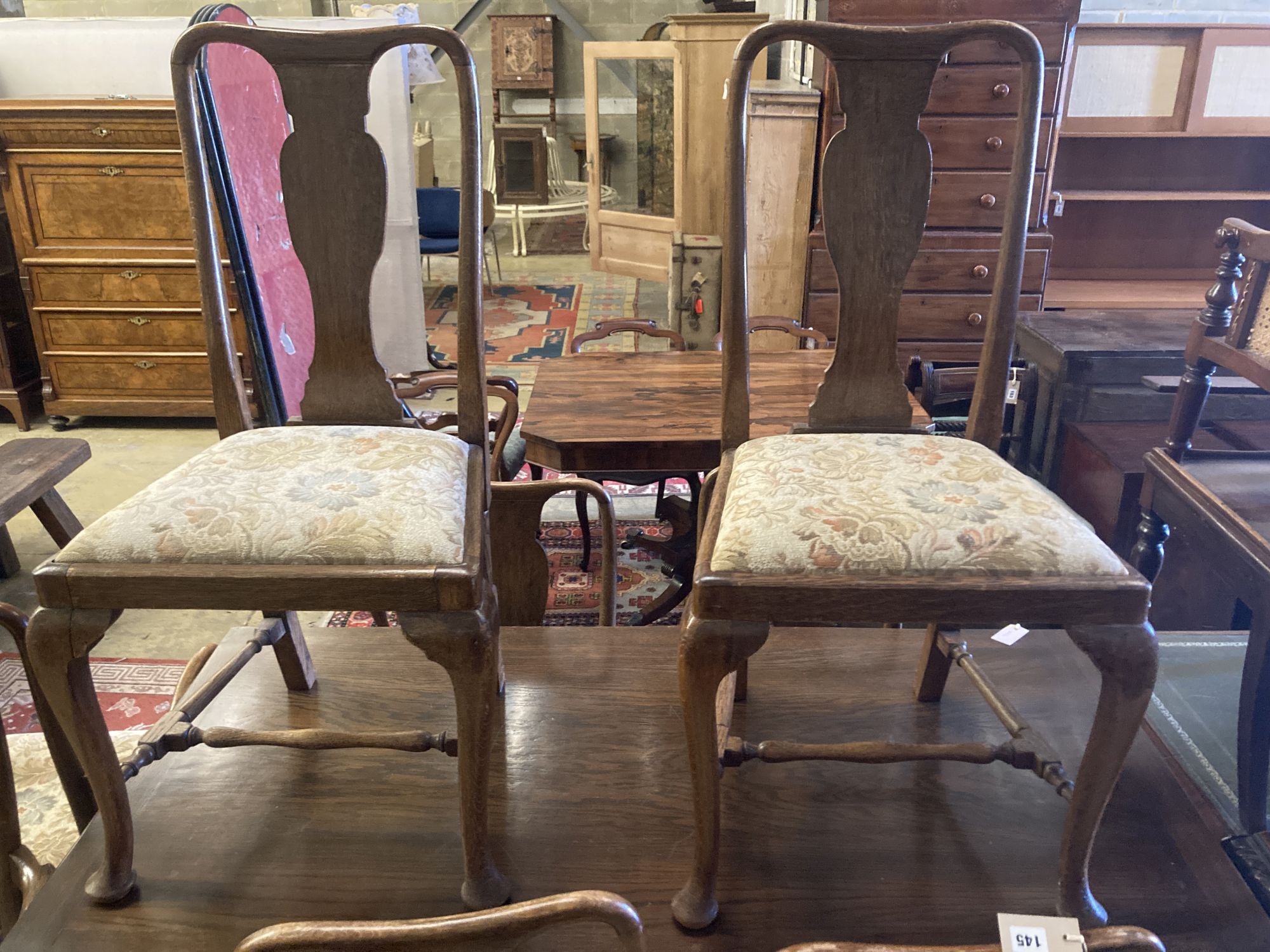A set of eight 1920s oak Queen Anne-style dining chairs, two with arms